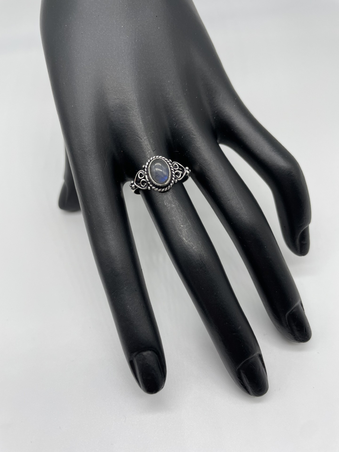 Ring is smaller design style with scroll shoulders and a Labradorite feature gemstone with blue flash