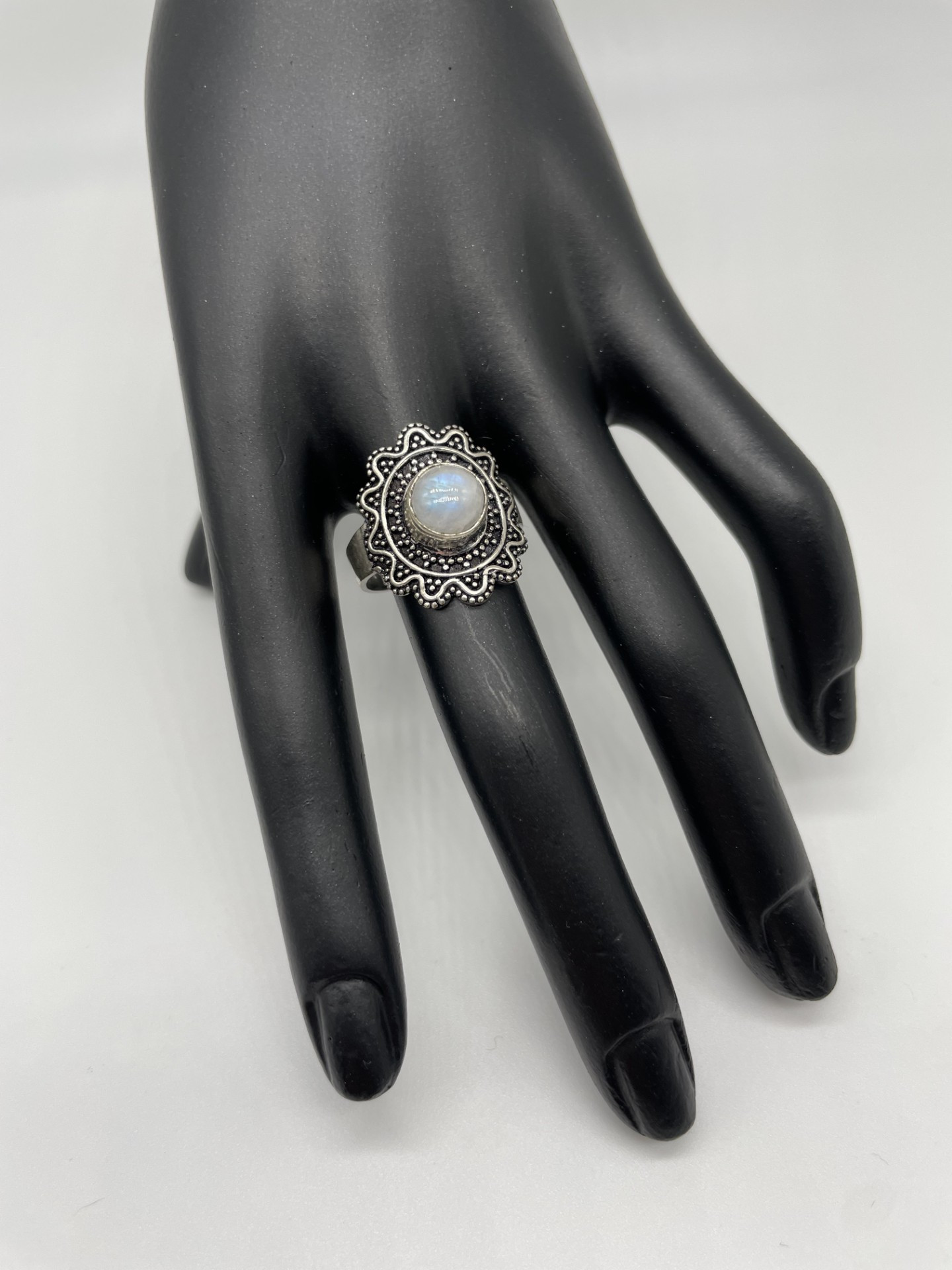 This Moonstone ring has a lovely blue flash. The ornate setting on this ring is as beautiful as the central stone itself. The ring is perfect for the current boho look but would complement any outfit.