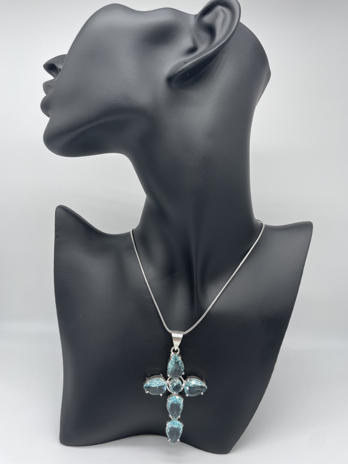Super Sparkles with this Blue Topaz Gemstone Cross which will get you noticed as it catches the light. The cross is 5.5cm in length and consists of 6 stones.