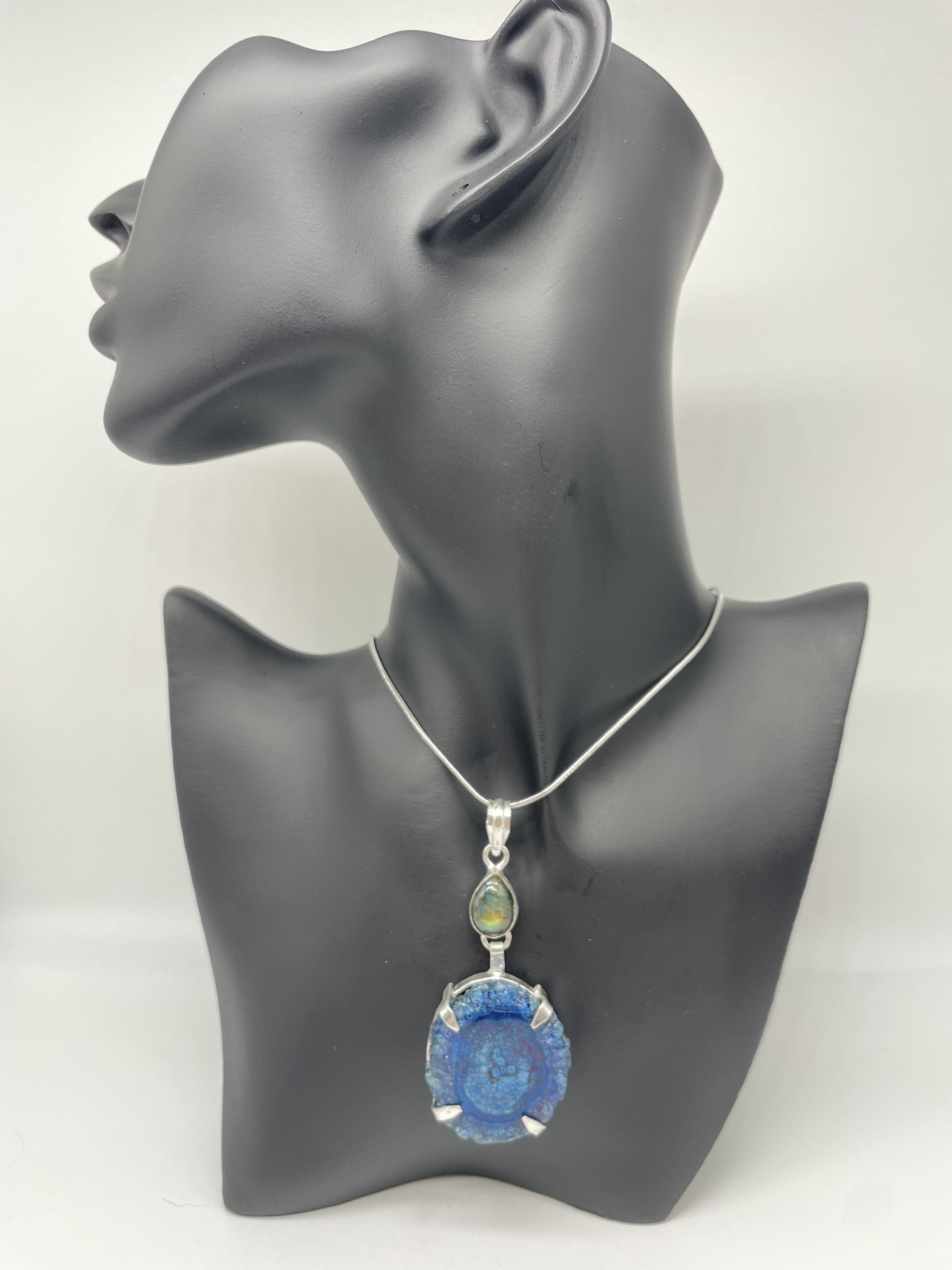 This is a very unusual necklace featuring a bright blue solar agate plus a labradorite accent stone.