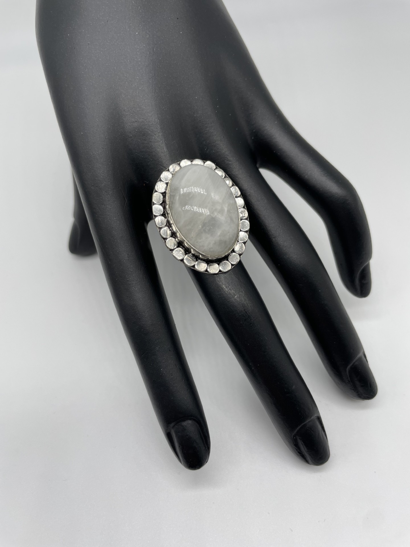 This Ring makes a big impact with one large rainbow moonstone and decorative edging.
