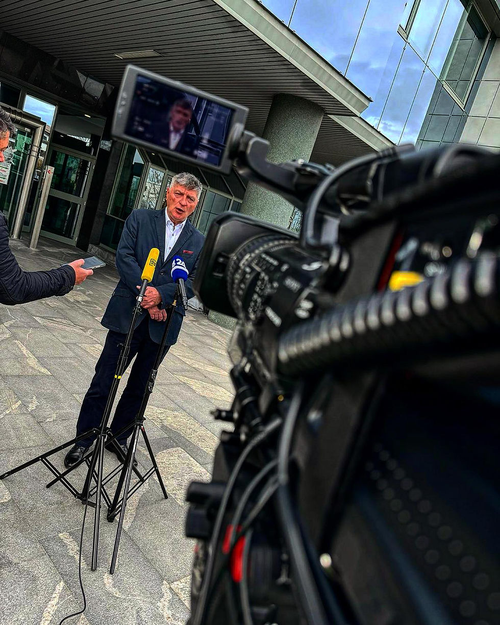 vzivo camera crew filming a press statement with broadcast cameras and microphones