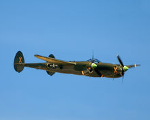 Free aircraft image of a green P-38 Lightning Aircraft Demonstration at the Gathering of Mustangs and Legends during the Rickenbacker Air Show in Columbus Ohio in 2007.