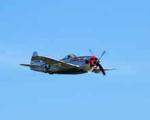 Free image of P-47 Thunderbolt ( (Hun Hunter XVI)) Aircraft Demonstration at the Gathering of Mustangs and Legends during the Rickenbacker Air Show in Columbus Ohio in 2007.
