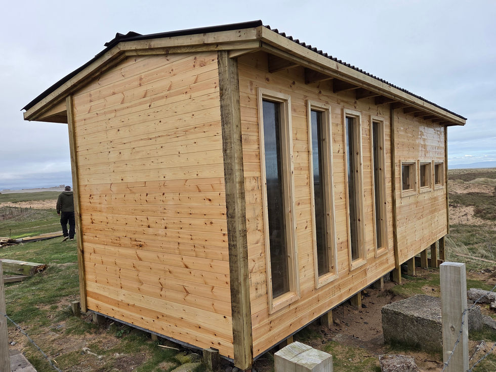 Custom-built raised garden room with vertical windows and seaview location, designed for natural light and ventilation