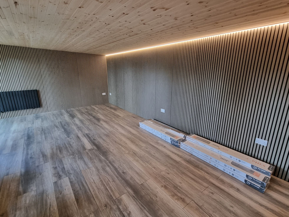 Timber cabin interior showing slatted feature wall and installed flooring