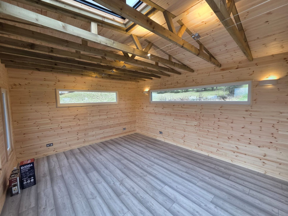 Two long clerestory picture windows and exposed rafters inside the finished garden room, Cumbria
