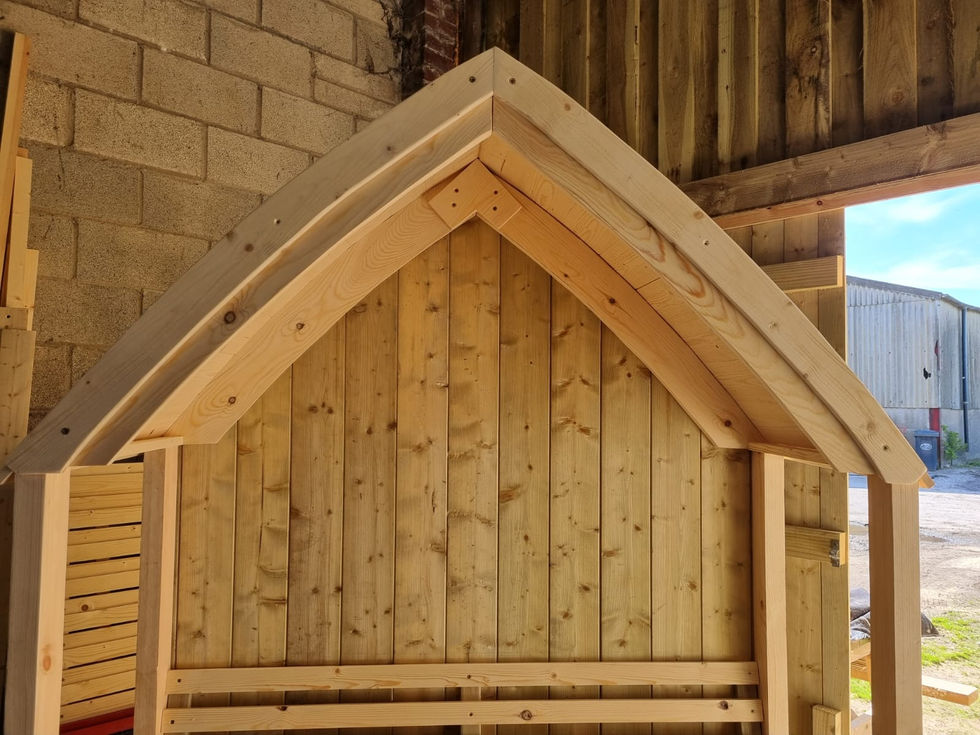 Detail of slatted bench and roof joinery on a handcrafted gothic garden seat, custom built in Cumbria.