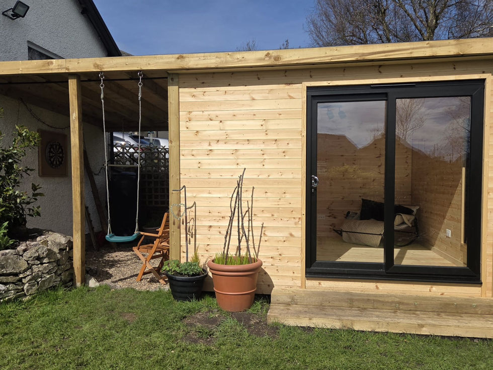 timber-clad garden room with anthracite sliding doors and a covered veranda swing seat, Cumbria