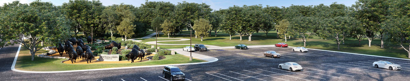 Entrance view of a public park featuring a buffalo sculpture installation, circular roundabout, landscaped greenery, parking lot, and tree-lined background.