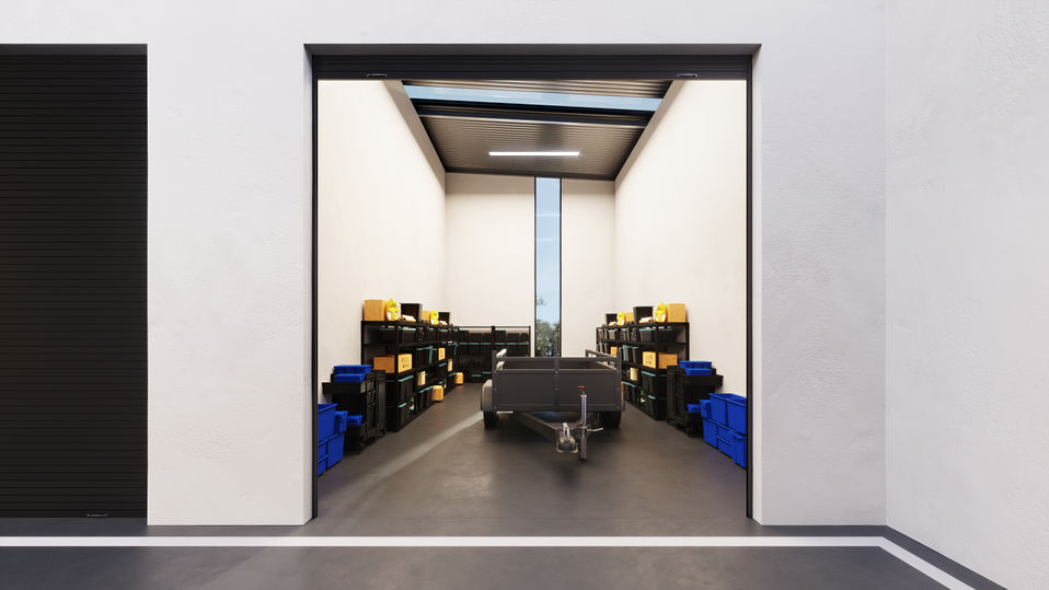 3D rendering of a bright industrial storage and work facility with wide central driveway and multiple high-clearance roller doors.