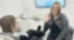 Vickie-Dental-Hygienist-sitting-with-dental-patient-smiling-and-waving.jpg