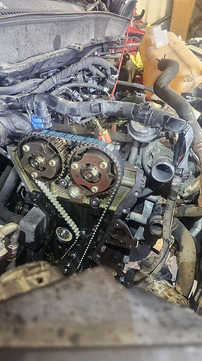 Close up view of vehicle engine gears with timing chain and blue mechanical markings