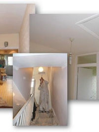 Staircase and hallway decorated in white with wooden handrail