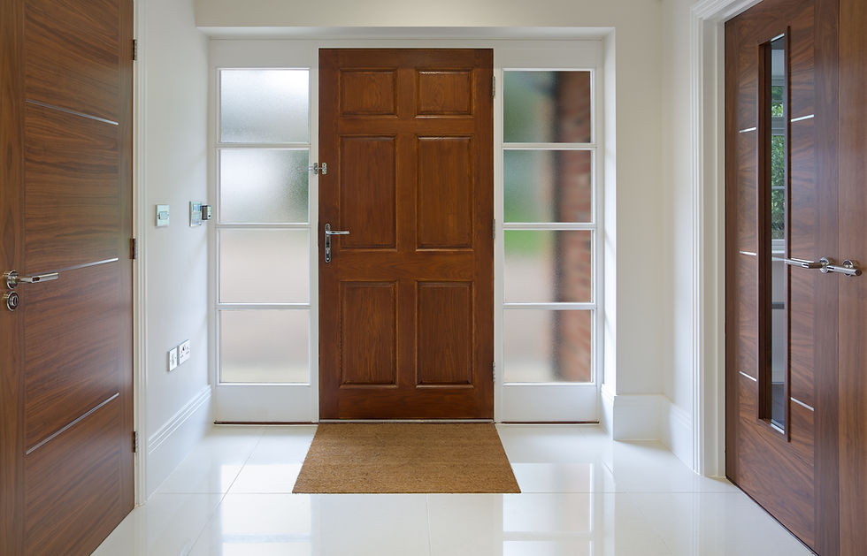 A pristine entryway features a central wooden door with frosted glass sidelights