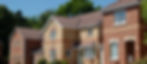 A row of colorful houses lined up along a street under a clear blue sky