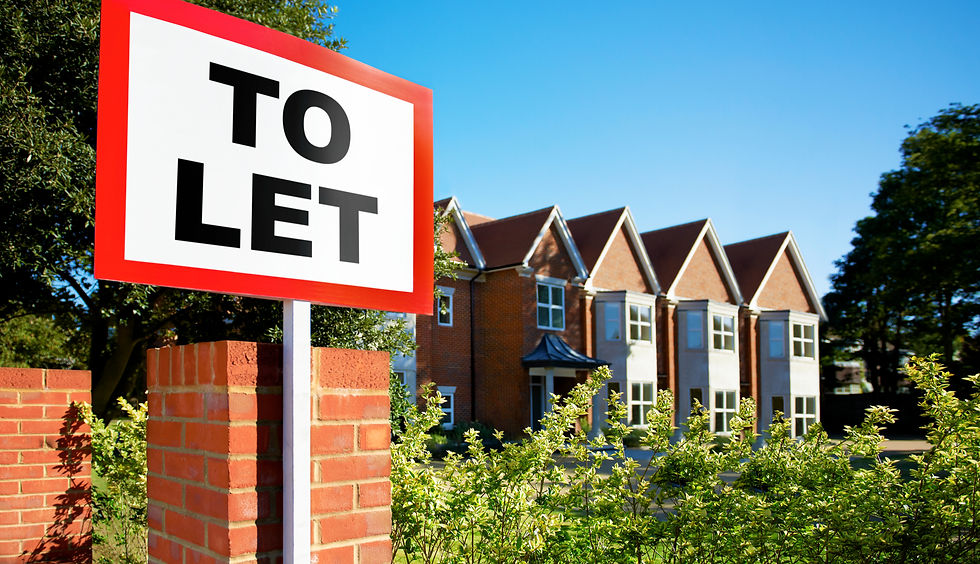Red 'To Let' sign in front of a row of modern brick townhouses with blue sky and green trees, conveying opportunity and residential appeal