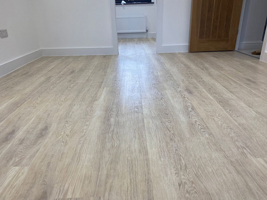 Modern grey wood effect vinyl flooring installed seamlessly throughout a room