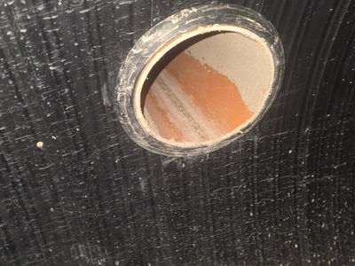Side connection inlet opening inside a black plastic drainage chamber or manhole