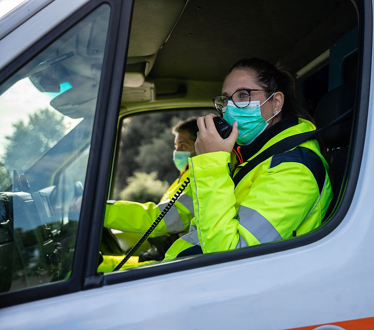Paramedic communicating via walkie talkie