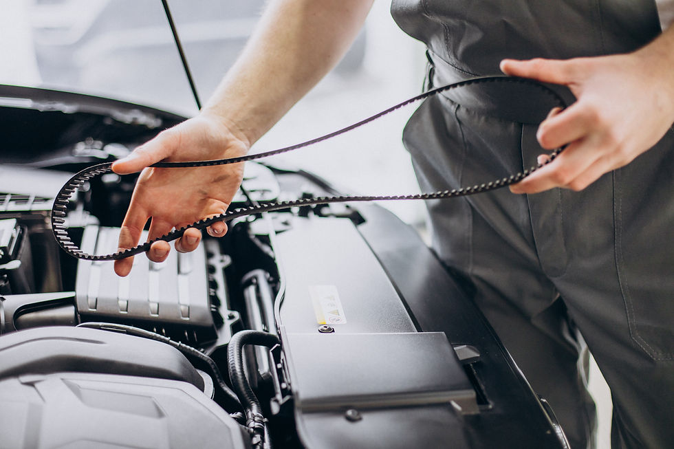 Hands holding a brand new car engine wet belt over an open vehicle bonnet