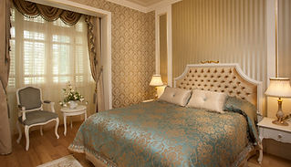 Elegant bedroom with an ornate gold and beige color scheme