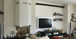 Living room decorated with fireplace surround and shelving