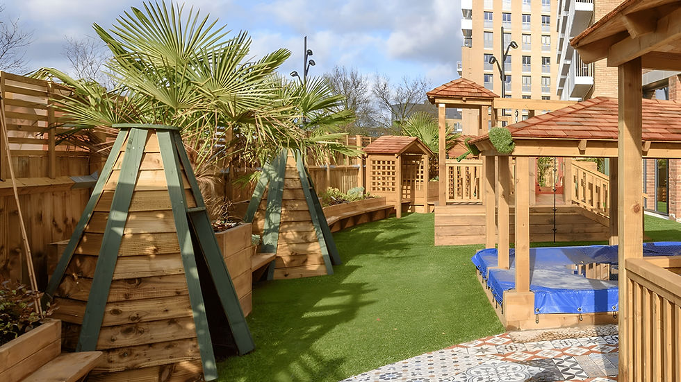 Outdoor wooden play area with climbing pyramid and gazebo in nursery garden
