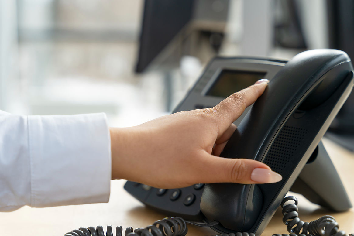 Receptionist handling office phone call