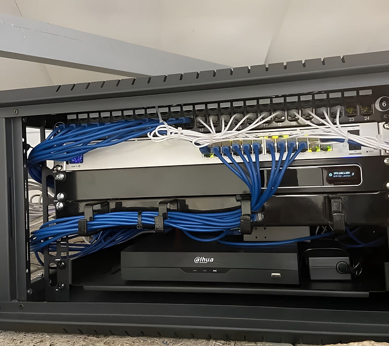 A neatly organized server rack with multiple network cables. Blue and white cables are connected to a switch, conveying a sense of order and efficiency