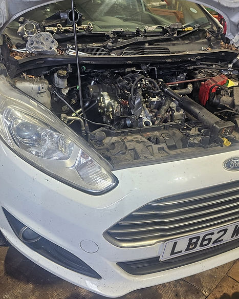 Close up of an open vehicle bonnet revealing internal engine components