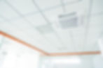 Ceiling view of a modern office with a central air conditioning vent