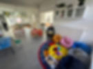 Bright, cheerful playroom with colorful bean bags on a circular rug