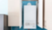 Wall-mounted white boiler with control knobs
