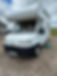 White motorhome parked on a gravel driveway