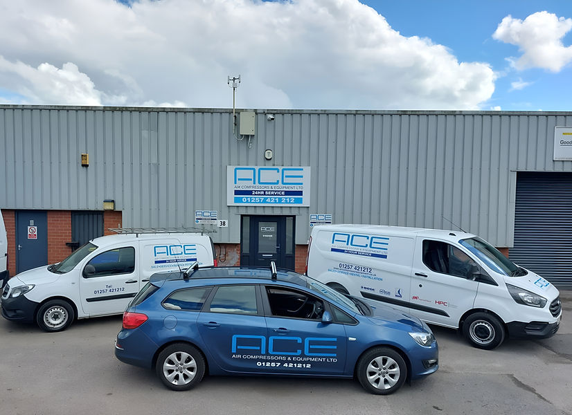 ACE company service vans and car parked outside industrial premises