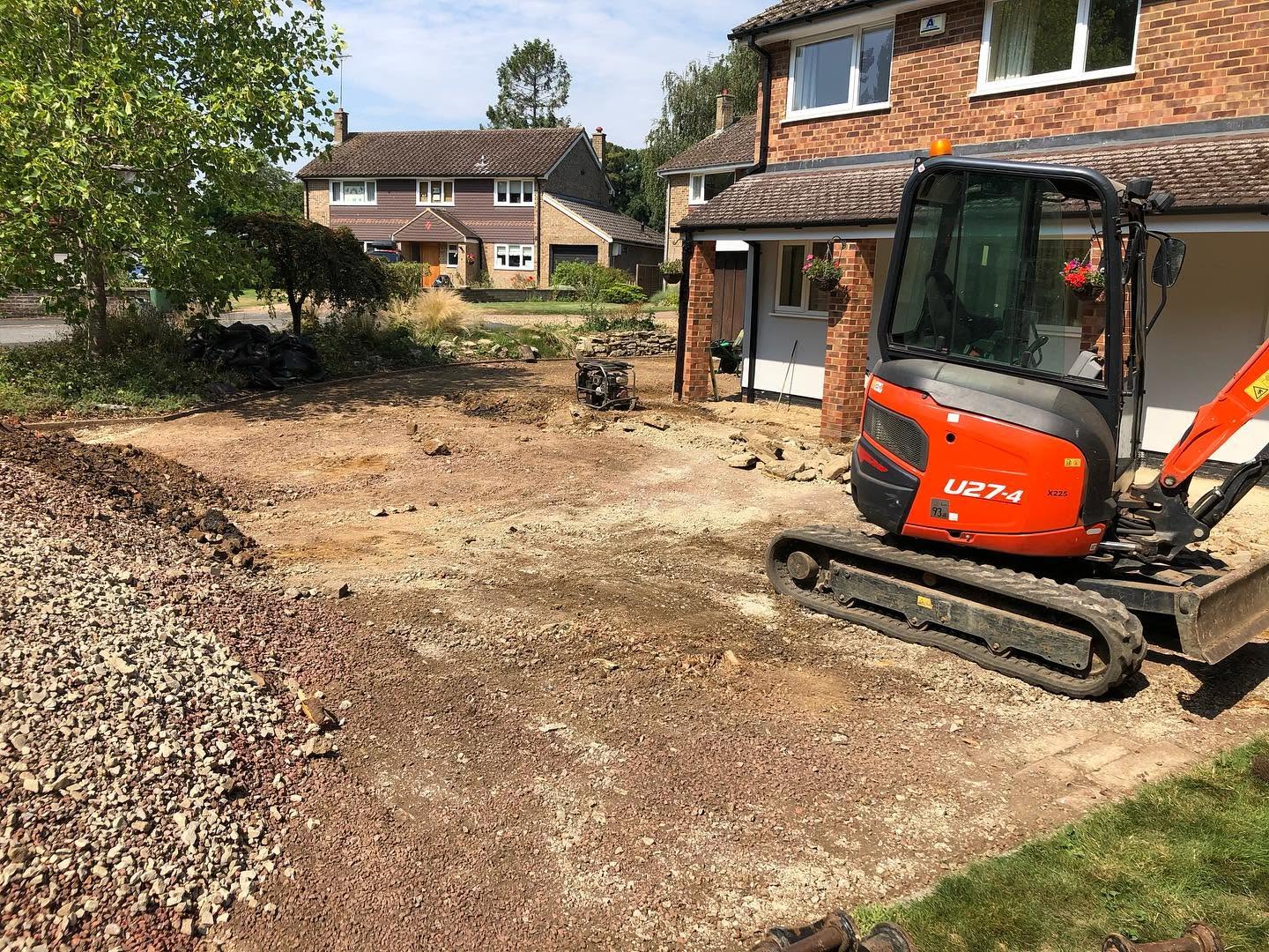 A small excavator parked in front of a residential house