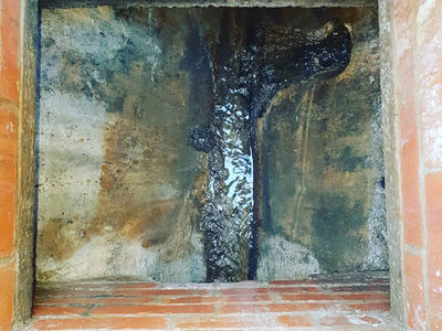 Overhead view of a cleared and clean square brick drainage inspection chamber