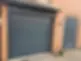 Brick house with dark grey garage door and matching front door