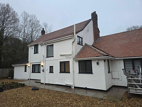 Large detached house with cleaned roof and walls.