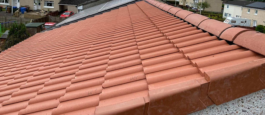 Wide view of red tiled roofs on a residential street