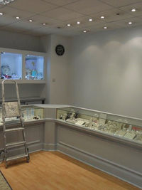 Commercial shop interior decorating with display cabinets and ladder