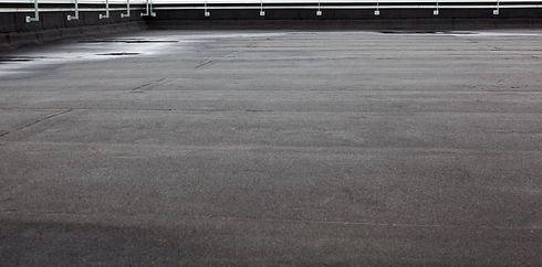 An flat roof with roofing and fencing