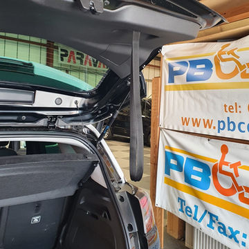 Rear boot area of a car fitted with a specialized automated mechanical hoist system