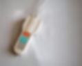 A hospital bed remote control with buttons for nurse call, light, and more on a white surface