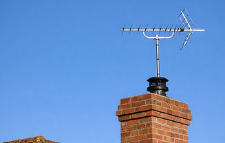 Television aerial on the top of a red brick chimney on a house in the UK_edited.jpg