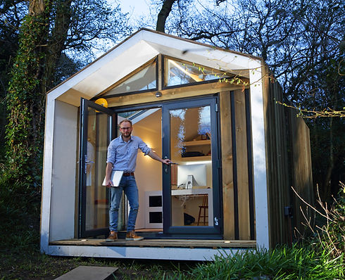Man stood outside home office in garden