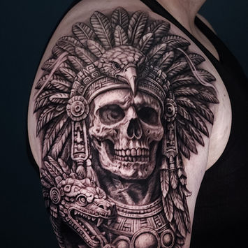 Black and grey Aztec-inspired skull shoulder tattoo by Inksertion Art Tattoo Studio in Miami