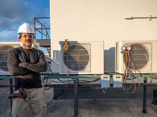 An HVAC technician standing on a roof