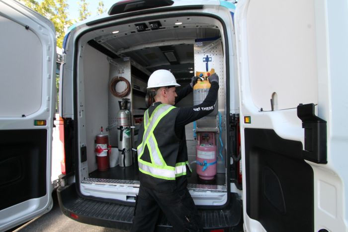An HVAC technician working out of an organized van